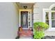Close-up of the front door with brick steps and decorative plants at 4640 Lambton Cir, Suwanee, GA 30024