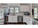 Kitchen featuring a stainless steel dishwasher, white cabinets, and subway tile backsplash at 4640 Lambton Cir, Suwanee, GA 30024