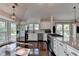 Gourmet kitchen with stainless steel appliances, custom cabinets, and hardwood floors at 4640 Lambton Cir, Suwanee, GA 30024