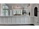 Bright kitchen with white cabinets, marble counters and stainless steel appliances at 4640 Lambton Cir, Suwanee, GA 30024