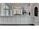 Bright kitchen with white cabinets, marble counters and stainless steel appliances at 4640 Lambton Cir, Suwanee, GA 30024