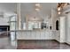Bright, open kitchen with white cabinetry, granite counters, and hardwood floors at 4640 Lambton Cir, Suwanee, GA 30024
