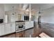 Kitchen with stainless steel oven and granite countertops open to living room at 4640 Lambton Cir, Suwanee, GA 30024