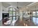 Spacious living room with hardwood floors, a fireplace, and large windows at 4640 Lambton Cir, Suwanee, GA 30024