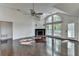 Open living room with hardwood floors, fireplace, and access to the outdoor deck at 4640 Lambton Cir, Suwanee, GA 30024
