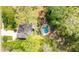 Aerial view of home with large in ground pool and wooded lot at 925 Upper Hembree Rd, Roswell, GA 30076