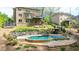Backyard pool with jacuzzi, built in bar, lush landscape, and trampoline at 925 Upper Hembree Rd, Roswell, GA 30076