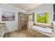 Spa-like bathroom with soaking tub, glass shower, and a serene view at 925 Upper Hembree Rd, Roswell, GA 30076
