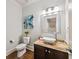 Elegant powder room with a vessel sink, granite countertop, and stylish decor at 925 Upper Hembree Rd, Roswell, GA 30076