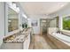 Bright bathroom with granite countertops, soaking tub, and a separate glass-enclosed shower at 925 Upper Hembree Rd, Roswell, GA 30076