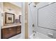 Bathroom featuring a shower-over-tub with herringbone-patterned subway tile and dark wood vanity at 925 Upper Hembree Rd, Roswell, GA 30076