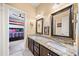Bathroom featuring a double vanity with granite countertops and dark wood cabinetry at 925 Upper Hembree Rd, Roswell, GA 30076