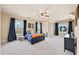 Spacious bedroom featuring a ceiling fan, large windows with natural light, and dark blue accents at 925 Upper Hembree Rd, Roswell, GA 30076