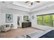 Bedroom with tray ceilings, large window overlooking a scenic view, and light, neutral colors at 925 Upper Hembree Rd, Roswell, GA 30076