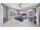Comfortable bedroom with a gray accent wall, large windows, and modern furniture at 925 Upper Hembree Rd, Roswell, GA 30076