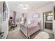 Charming bedroom with pink accents, and an adjacent ensuite bathroom at 925 Upper Hembree Rd, Roswell, GA 30076