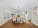 Formal dining room with hardwood floors, wainscoting and modern chandelier at 925 Upper Hembree Rd, Roswell, GA 30076