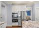 Modern kitchen with stainless steel appliances and granite countertops at 925 Upper Hembree Rd, Roswell, GA 30076