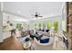 Open-concept living room with large windows, stone fireplace, and hardwood floors at 925 Upper Hembree Rd, Roswell, GA 30076