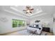 Serene bedroom featuring tray ceilings, large windows, and sophisticated decor at 925 Upper Hembree Rd, Roswell, GA 30076