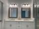 Bathroom vanity with double sinks, framed mirrors and modern lighting at 102 Birch Tree Way, Cumming, GA 30040