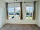 Bright bedroom featuring large windows and neutral carpeting at 102 Birch Tree Way, Cumming, GA 30040