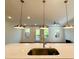 Open concept kitchen with marble counters, stainless steel sink, and views of the dining area at 102 Birch Tree Way, Cumming, GA 30040