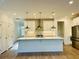 Spacious kitchen featuring a large island, stainless steel appliances, and modern lighting at 102 Birch Tree Way, Cumming, GA 30040
