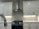Kitchen featuring stainless steel range hood and gas range at 102 Birch Tree Way, Cumming, GA 30040