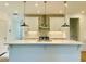 Large kitchen island with stainless steel fixtures and white cabinets, perfect for entertaining at 102 Birch Tree Way, Cumming, GA 30040