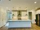 Well-lit kitchen with stainless steel appliances, white cabinetry, and hardwood floors at 102 Birch Tree Way, Cumming, GA 30040