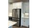 Modern kitchen featuring stainless steel refrigerator and white cabinets at 102 Birch Tree Way, Cumming, GA 30040