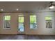 Bright living room with hardwood floors, recessed lighting, and views of the fenced backyard at 102 Birch Tree Way, Cumming, GA 30040