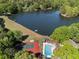 Stunning aerial view featuring a community pool, tennis courts, and a tranquil lake surrounded by lush greenery at 105 Woodmeade Nw Way, Marietta, GA 30064
