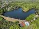 Breathtaking aerial view showcasing a serene lake surrounded by verdant trees and community amenities at 105 Woodmeade Nw Way, Marietta, GA 30064
