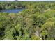 Lush aerial view of a lake surrounded by dense trees, showing natural beauty and community at 105 Woodmeade Nw Way, Marietta, GA 30064