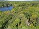 Scenic aerial view of a home nestled among lush trees near a serene lake at 105 Woodmeade Nw Way, Marietta, GA 30064