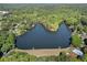 Expansive aerial view of a peaceful lake surrounded by lush green trees and neighborhood homes at 105 Woodmeade Nw Way, Marietta, GA 30064
