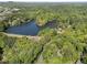 Serene aerial view of a tranquil lake surrounded by lush greenery and neighborhood at 105 Woodmeade Nw Way, Marietta, GA 30064