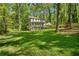 Spacious backyard with lush lawn and a charming two-story home in a serene setting at 105 Woodmeade Nw Way, Marietta, GA 30064