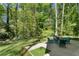 Large backyard patio surrounded by green grass and trees, perfect for outdoor gatherings and relaxation at 105 Woodmeade Nw Way, Marietta, GA 30064