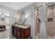 Bright bathroom featuring a walk-in shower, granite countertop, and dark wood vanity at 105 Woodmeade Nw Way, Marietta, GA 30064