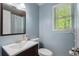 This bathroom features a mirror and a window at 105 Woodmeade Nw Way, Marietta, GA 30064
