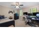 This bedroom features a ceiling fan, desk, and a comfortable bed at 105 Woodmeade Nw Way, Marietta, GA 30064