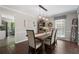 Charming dining room featuring wood floors, a rustic table, and elegant light fixtures at 105 Woodmeade Nw Way, Marietta, GA 30064