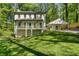 Charming two-story home featuring a spacious front porch and adjacent carport nestled in a wooded setting at 105 Woodmeade Nw Way, Marietta, GA 30064