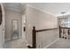 Upstairs hallway featuring a decorative chandelier and open doors leading to other rooms at 105 Woodmeade Nw Way, Marietta, GA 30064