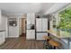 Eat-in kitchen featuring light wood floors, bar seating, and new white appliances at 105 Woodmeade Nw Way, Marietta, GA 30064