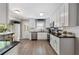 Bright kitchen featuring white cabinets, granite countertops, and modern stainless steel appliances at 105 Woodmeade Nw Way, Marietta, GA 30064