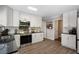 Bright kitchen featuring stainless steel appliances, black countertops, and white cabinets at 105 Woodmeade Nw Way, Marietta, GA 30064